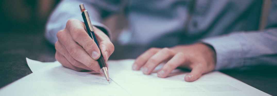 Man Signing Paperwork