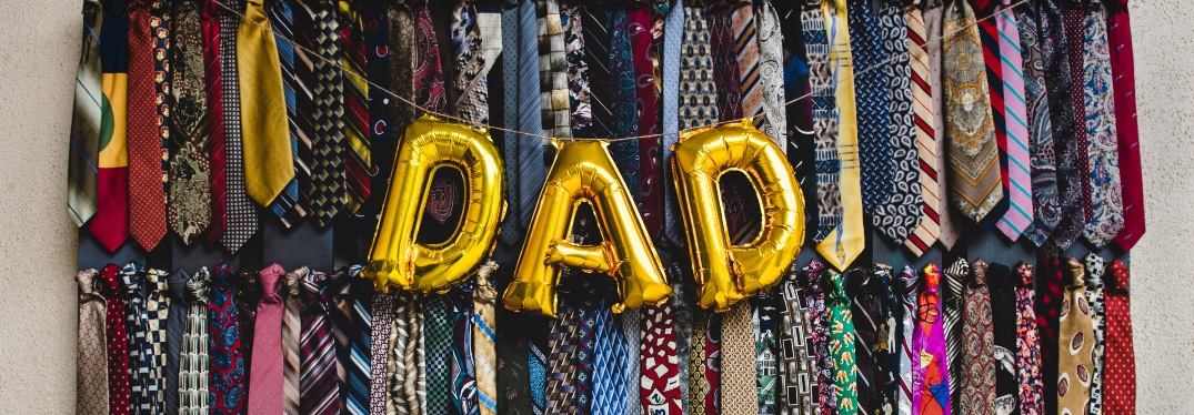 "DAD" in Gold Balloons in Front of Necktie Background