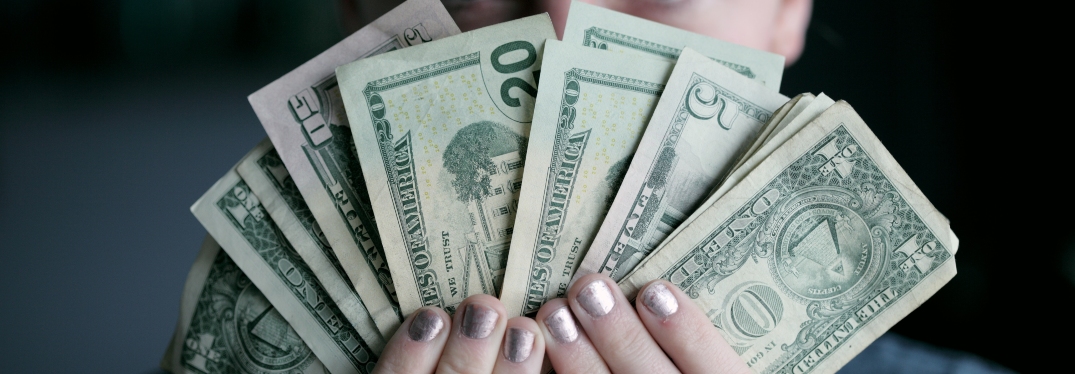 Hands with Painted Fingernails Holding Money