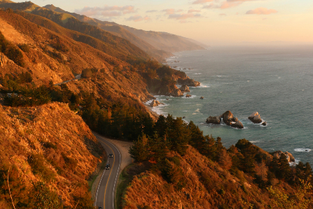 Coastal highway with ocean and mountain views