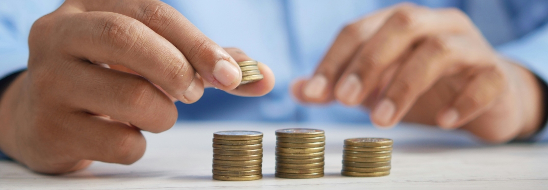 Man stacking coins on table