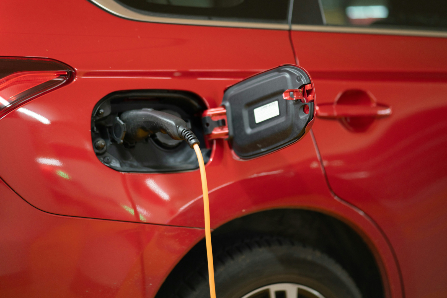 Red EV Plugged in to Charge