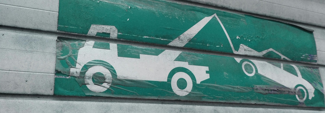 Painted sign of truck towing car